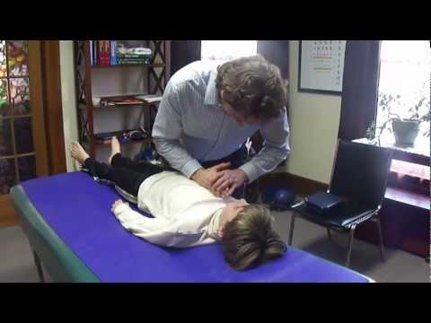 Chiropractor demonstrates an adjustment to relieve pain